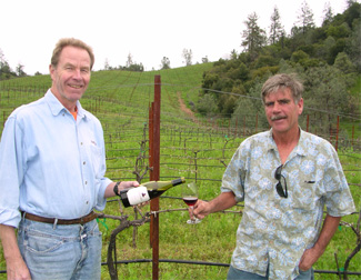 Josh Jensen pours vineyard manager Jim Ryan a glass of the Pinot Noir produced from the Ryan Vineyard in which they stand.
